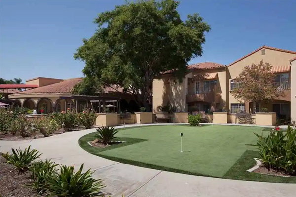 A golf course in front of a building.